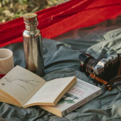 Thermos books and photo camera on camp tent